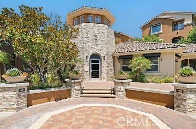 23785 Western Cedar Ct, Valencia, CA 91354 - back of house with a tile roof, stone siding, and stucco siding
