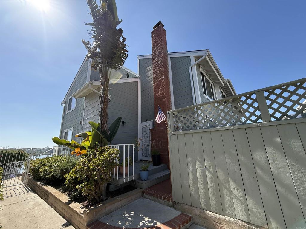 2525 Jefferson St Unit K, Carlsbad, CA 92008 - view of home's exterior with a chimney and a gate