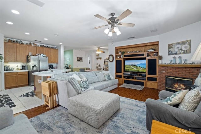 34722 Fairport Way, Yucaipa, CA 92399 - living room featuring a ceiling fan, recessed lighting, a fireplace, and light wood-style floors