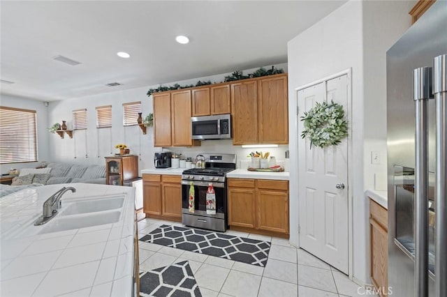 34722 Fairport Way, Yucaipa, CA 92399 - kitchen featuring stainless steel appliances, open floor plan, tile counters, light tile patterned floors, and recessed lighting