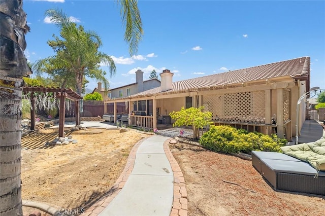 34722 Fairport Way, Yucaipa, CA 92399 - rear view of property featuring a chimney, a pergola, a fenced backyard, a patio, and a tile roof