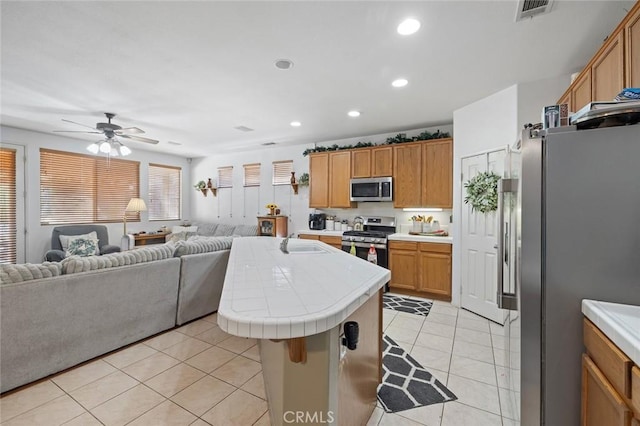 34722 Fairport Way, Yucaipa, CA 92399 - kitchen with open floor plan, stainless steel appliances, tile countertops, light tile patterned floors, and recessed lighting