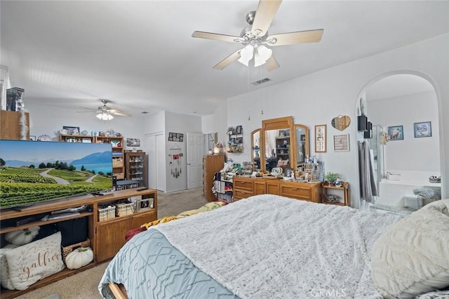 34722 Fairport Way, Yucaipa, CA 92399 - bedroom featuring arched walkways, carpet, ceiling fan, and connected bathroom