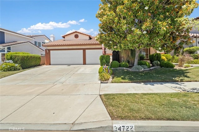 34722 Fairport Way, Yucaipa, CA 92399 - mediterranean / spanish home featuring an attached garage, driveway, a tile roof, a front yard, and stucco siding