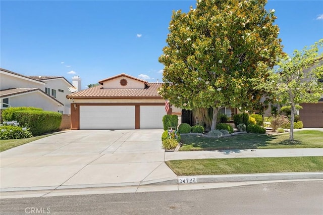 34722 Fairport Way, Yucaipa, CA 92399 - view of front facade featuring an attached garage, driveway, a tiled roof, a front lawn, and stucco siding