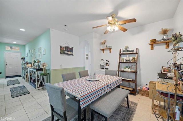 34722 Fairport Way, Yucaipa, CA 92399 - dining area with arched walkways, light tile patterned floors, a ceiling fan, recessed lighting, and a wainscoted wall