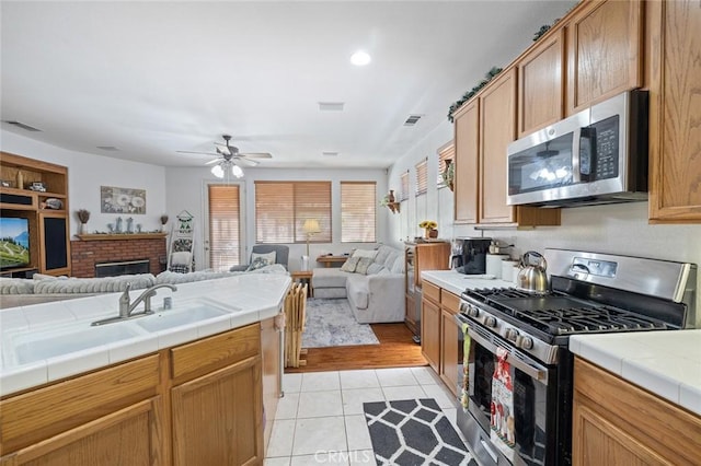 34722 Fairport Way, Yucaipa, CA 92399 - kitchen featuring stainless steel appliances, open floor plan, tile countertops, a ceiling fan, and recessed lighting