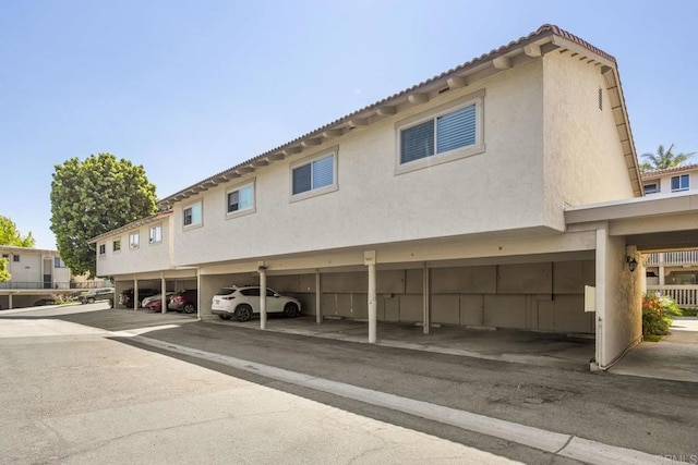 2352 Altisma Way Unit 13, Carlsbad, CA 92009 - rear view of property featuring covered parking and stucco siding