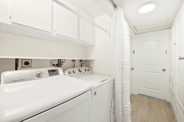 2352 Altisma Way Unit 13, Carlsbad, CA 92009 - laundry area featuring light wood finished floors, washing machine and dryer, and cabinet space
