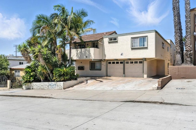 4074 48th St Unit 3, San Diego, CA 92105 - view of front of property with an attached garage, stucco siding, and driveway