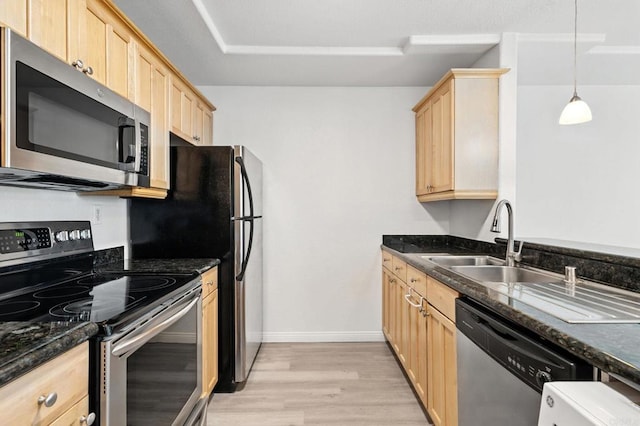 4074 48th St Unit 3, San Diego, CA 92105 - kitchen with stainless steel appliances, light brown cabinetry, light wood-style flooring, and dark stone counters