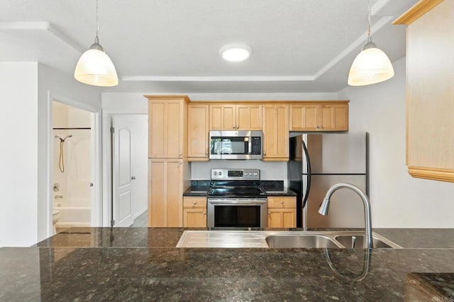 4074 48th St Unit 3, San Diego, CA 92105 - kitchen with appliances with stainless steel finishes, light brown cabinetry, and pendant lighting