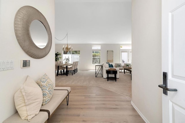 4981 Lerkas Way, Oceanside, CA 92056 - hallway with a chandelier and light wood-style flooring