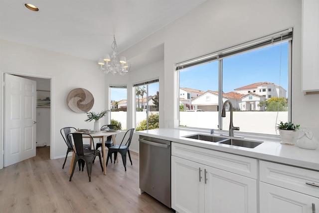 4981 Lerkas Way, Oceanside, CA 92056 - kitchen featuring dishwasher, a chandelier, white cabinets, light wood-style flooring, and light countertops
