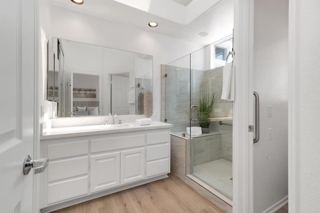 4981 Lerkas Way, Oceanside, CA 92056 - ensuite bathroom with vanity, a stall shower, wood finished floors, and recessed lighting