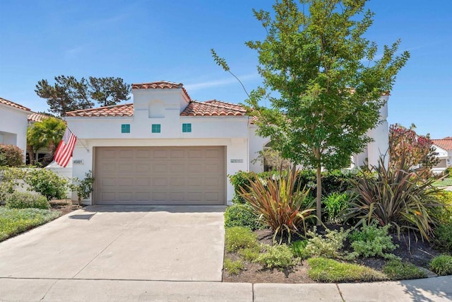 4981 Lerkas Way, Oceanside, CA 92056 - mediterranean / spanish house with driveway, stucco siding, a tiled roof, and an attached garage