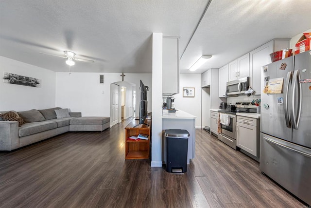 2041 E Grand Ave Unit 19, Escondido, CA 92027 - kitchen with appliances with stainless steel finishes, open floor plan, light countertops, dark wood finished floors, and a textured ceiling