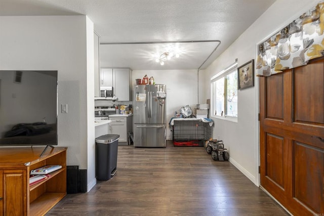 2041 E Grand Ave Unit 19, Escondido, CA 92027 - kitchen with appliances with stainless steel finishes, dark wood-style floors, and light countertops