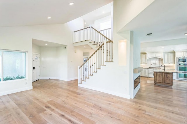 15716 Milne Cir, Moorpark, CA 93021 - foyer entrance featuring stairway, light wood-type flooring, high vaulted ceiling, and recessed lighting