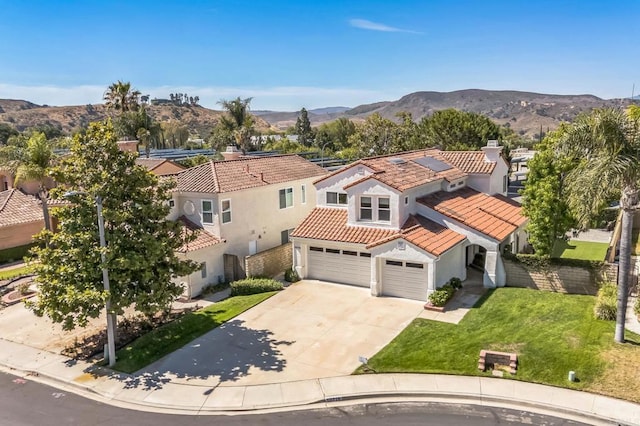 15716 Milne Cir, Moorpark, CA 93021 - view of front of property featuring stucco siding, a tile roof, driveway, a garage, and roof mounted solar panels