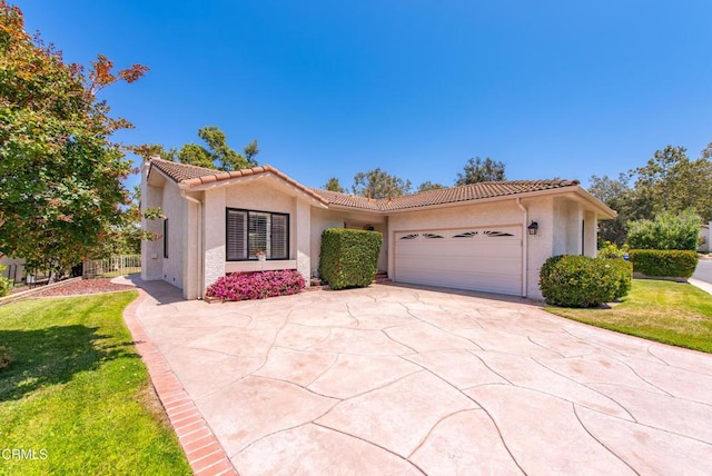 6357 Irena Ave, Camarillo, CA 93012 - view of front facade featuring stucco siding, a tiled roof, a garage, and driveway