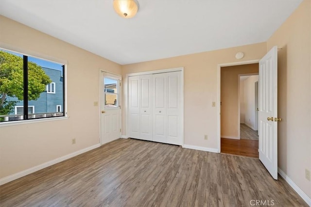 1232 10th St, Los Osos, CA 93402 - unfurnished bedroom featuring wood finished floors and a closet