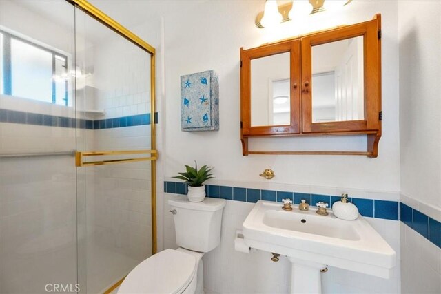 1232 10th St, Los Osos, CA 93402 - bathroom with tile walls, a shower stall, and a wainscoted wall