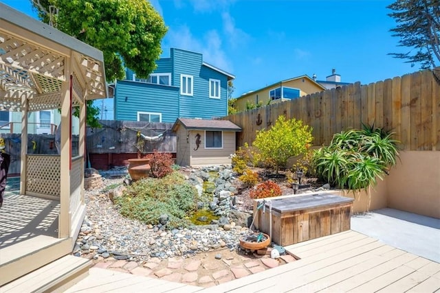 1232 10th St, Los Osos, CA 93402 - wooden terrace with a fenced backyard, a storage shed, and a hot tub