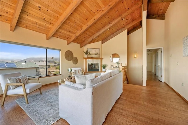1232 10th St, Los Osos, CA 93402 - living area featuring a wooden ceiling with exposed beams, light wood-style flooring, high vaulted ceiling, and a fireplace