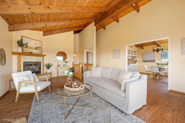 1232 10th St, Los Osos, CA 93402 - living room featuring a wooden ceiling with exposed beams, wood finished floors, a chandelier, a tiled fireplace, and high vaulted ceiling