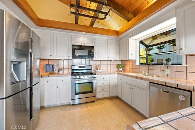 1232 10th St, Los Osos, CA 93402 - kitchen featuring stainless steel appliances, wood ceiling, tile countertops, white cabinets, and tasteful backsplash