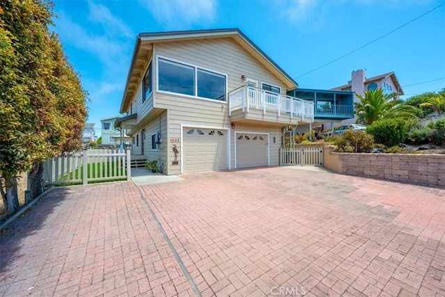 1232 10th St, Los Osos, CA 93402 - view of front of property featuring a garage, decorative driveway, and a balcony