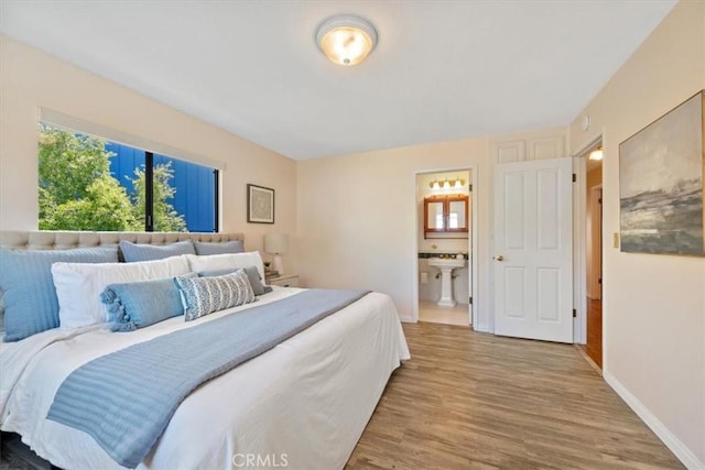 1232 10th St, Los Osos, CA 93402 - bedroom featuring multiple windows, wood finished floors, and ensuite bathroom
