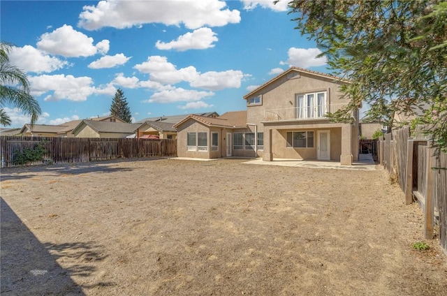 10527 Rose River Falls Ave, Bakersfield, CA 93312 - rear view of house with stucco siding, a patio area, a fenced backyard, a balcony, and french doors
