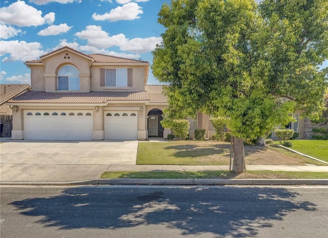 10527 Rose River Falls Ave, Bakersfield, CA 93312 - mediterranean / spanish home featuring a tiled roof, stucco siding, driveway, an attached garage, and a front yard