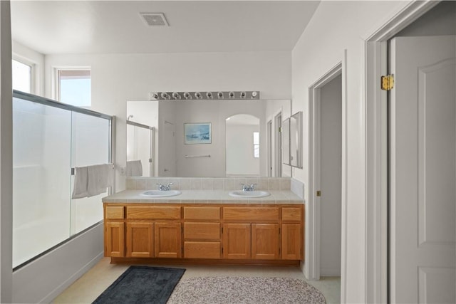 10527 Rose River Falls Ave, Bakersfield, CA 93312 - bathroom with double vanity and enclosed tub / shower combo