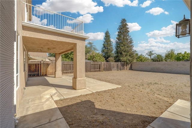 10527 Rose River Falls Ave, Bakersfield, CA 93312 - fenced backyard with a patio area and a balcony