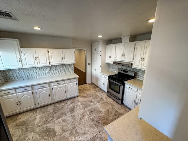 4021 York Blvd, Glassell Park, CA 90065 - kitchen with stainless steel gas range oven, under cabinet range hood, white cabinets, light countertops, and decorative backsplash