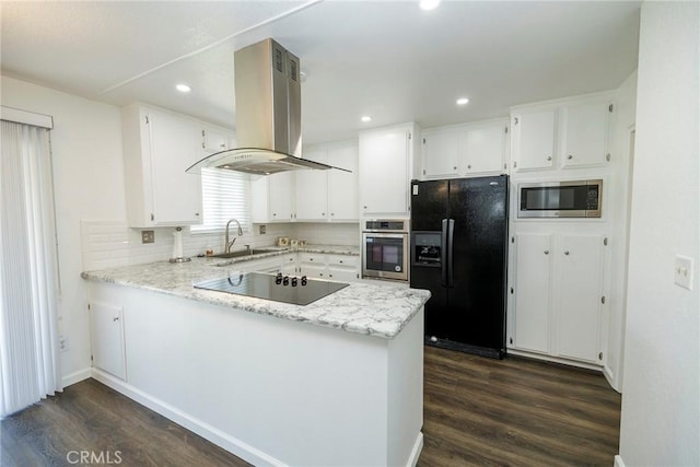 1721 Myrtlewood Dr, Ceres, CA 95307 - kitchen featuring black appliances, island exhaust hood, dark wood finished floors, a peninsula, and white cabinets