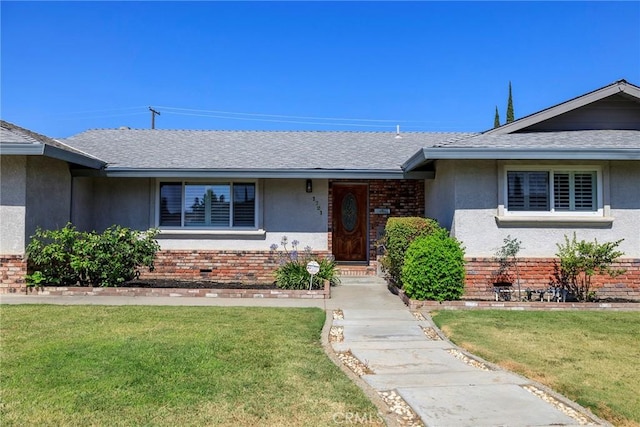 1721 Myrtlewood Dr, Ceres, CA 95307 - ranch-style home featuring brick siding, a front yard, stucco siding, and a shingled roof