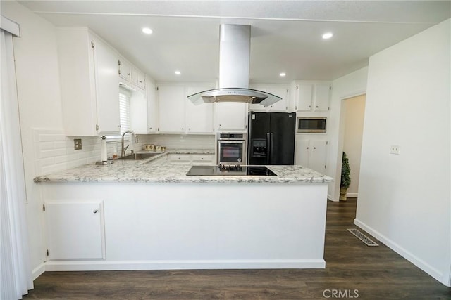 1721 Myrtlewood Dr, Ceres, CA 95307 - kitchen with black appliances, island range hood, a peninsula, backsplash, and white cabinets