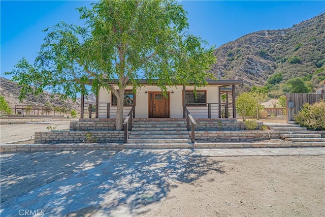 29701 Jackson St, Castaic, CA 91384 - view of front of property featuring a mountain view, stucco siding, and covered porch