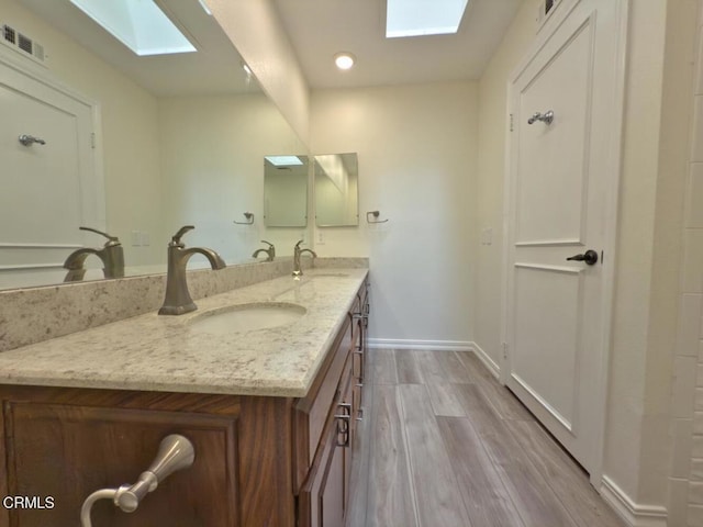 37134 Village 37, Camarillo, CA 93012 - full bath with a skylight, double vanity, wood finished floors, and recessed lighting
