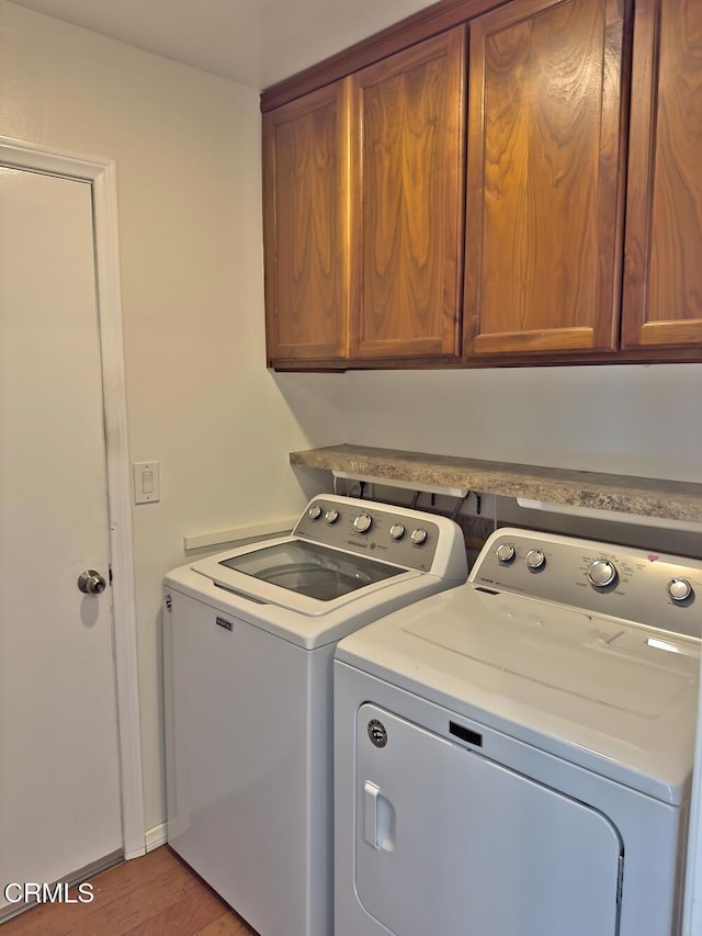 37134 Village 37, Camarillo, CA 93012 - laundry area featuring washing machine and dryer, cabinet space, and light wood finished floors