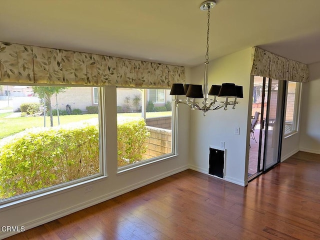 37134 Village 37, Camarillo, CA 93012 - unfurnished dining area with healthy amount of natural light, a chandelier, and dark wood-style flooring