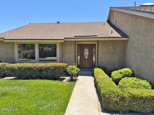 37134 Village 37, Camarillo, CA 93012 - property entrance featuring stucco siding, roof with shingles, and a lawn