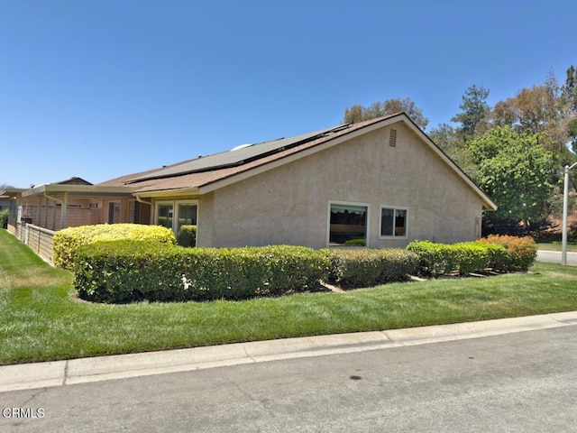 37134 Village 37, Camarillo, CA 93012 - view of home's exterior with solar panels, stucco siding, and a yard