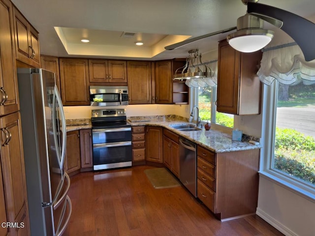 37134 Village 37, Camarillo, CA 93012 - kitchen featuring stainless steel appliances, a tray ceiling, dark wood-style flooring, light stone counters, and recessed lighting