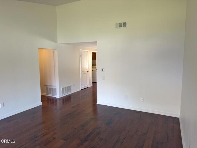 37134 Village 37, Camarillo, CA 93012 - spare room with dark wood-style floors, a high ceiling, and washer / clothes dryer