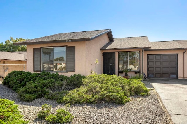 1523 Temple Heights Dr, Oceanside, CA 92056 - view of front of property featuring an attached garage, concrete driveway, stucco siding, and roof with shingles